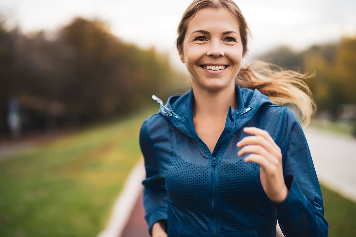 woman running and smiling outdoors after thyroid surgery in Marion and Mount Vernon
